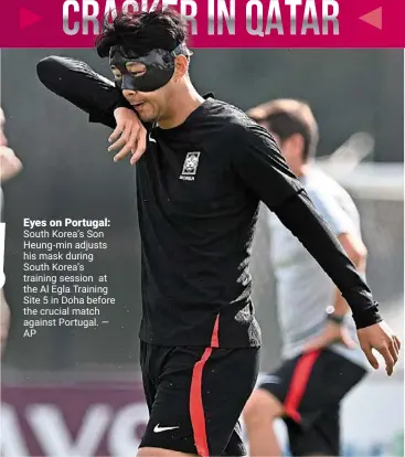  ?? ?? Eyes on portugal: South Korea’s Son Heung-min adjusts his mask during South Korea’s training session at the al egla Training Site 5 in doha before the crucial match against Portugal. — ap