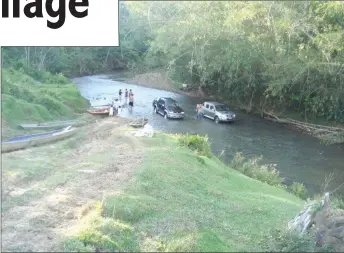  ??  ?? Travellers have their cars washed in a shallow river.