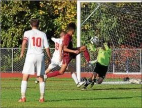  ?? AUSTIN HERTZOG — DIGITAL FIRST MEDIA ?? Holy Ghost Prep goalkeeper Harry Scuron collects the ball under pressure from Pottsgrove’s Kevin Benitez during their District 1-AAA boys soccer semifinal Wednesday.