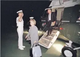  ?? U.S. National Archives ?? WITH HIS WIFE, Lynne, the vice president exits Marine Two at Camp David, a location that was undisclose­d at the time.