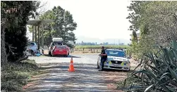  ?? STUFF ?? Police examine the property in Gordonton following the deadly tussle between father and son.