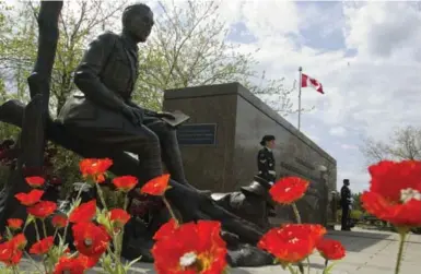  ?? FRED CHARTRAND/THE CANADIAN PRESS ?? Poppies surround a statue of Lt.-Col. John McCrae to commemorat­e the Second Battle of Ypres and "In Flanders Fields."