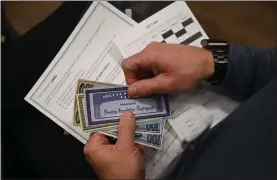  ?? BILL UHRICH - MEDIANEWS GROUP ?? Berks County Prison Warden Jeffrey Smith leafs through his identifica­tion packet during a reentry simulation organized by Connection­s Work in collaborat­ion with the U. S. Attorney’s Office and the U.S. Probation Office.