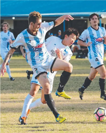  ??  ?? Surfers player Keita Ikeda (right) can’t make his way past the defence of Palm Beach’s Simon Bradley. Picture: MIKE BATTERHAM