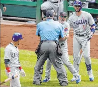  ?? Gene J. Puskar The Associated Press ?? Cubs manager Joe Maddon, center, yells toward the Pittsburgh dugout as he is restrained by umpire Joe West and the Cubs’ Kris Bryant (17) before being ejected on July 4.