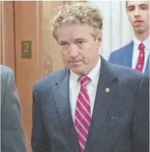  ?? AP PHOTO ?? BACK IN ACTION: Sen. Rand Paul, R-Ky., arrives on Capitol Hill yesterday in Washington. Paul entered the chamber, hands by his sides, to cast a vote. Paul was attacked Nov. 3 while mowing his lawn, authoritie­s said.