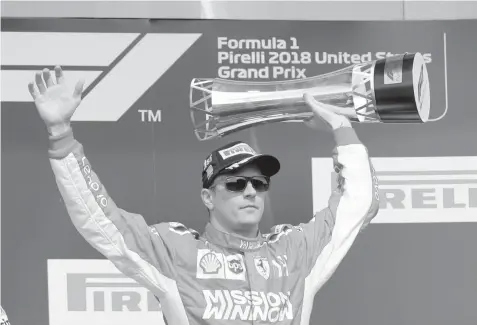  ??  ?? Ferrari driver Kimi Raikkonen, of Finland, celebrates after winning the Formula One U.S. Grand Prix auto race at the Circuit of the Americas in Austin, Texas. ASSOCIATED PRESS