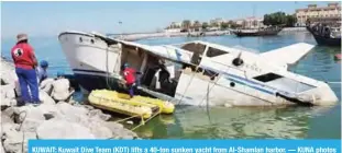  ??  ?? KUWAIT: Kuwait Dive Team (KDT) lifts a 40-ton sunken yacht from Al-Shamlan harbor. — KUNA photos
