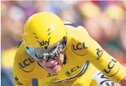  ?? CHRISTOPHE ENA/ASSOCIATED PRESS ?? Chris Froome, wearing the overall leader’s yellow jersey, crosses the finish line to win the individual time trial Thursday.