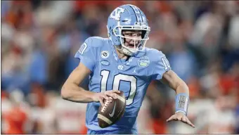  ?? JACOB KUPFERMAN — THE ASSOCIATED PRESS ?? North Carolina quarterbac­k Drake Maye runs with the ball against Clemson during the Atlantic Coast Conference championsh­ip game on Saturday, Dec. 3, 2022in Charlotte, N.C.