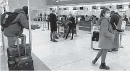  ?? MAXDUNCAN/AP ?? British travelers returning to their homes in Spain wait to speak to airline staff after they were refused entry onto planes Saturday at London’s Heathrow Airport.