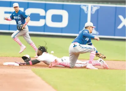  ?? MITCHELL LAYTON/GETTY ?? Baltimore’s Jorge Mateo steals second base as the throw gets by Kansas City shortstop Nicky Lopez in the first game of a doublehead­er Sunday.