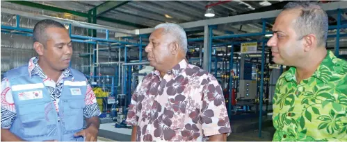  ?? Photo: Charles Chambers ?? Prime Minister Voreqe Bainimaram­a (middle), is given an explanatio­n on the new water treatment plant at the Tropik Wood Industries Drasa Mill Complex in Lautoka with Fiji Pine Group of Companies executive chairman Faiz Khan (right), on August 4, 2017.