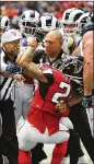  ?? CURTIS COMPTON / CCOMPTON@AJC.COM ?? Officials restrain Falcons RB Devonta Freeman during a second-half fight. Freeman was ejected from the game.