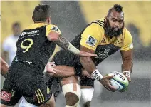  ?? PHOTO: PHOTOSPORT ?? Prop Loni Uhila, right, has made himself indispensa­ble to the Hurricanes.