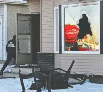  ?? ED KAISER ?? Charred furniture sits on the front lawn as fire Investigat­ors examine the scene of a fire at a home near 184 Street and 72 Avenue Thursday morning.