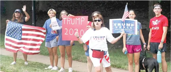  ?? PATRICK SEMANSKY/AP ?? Supporters of President Donald Trump stand outside Trump National Golf Club in Sterling, Virginia, last Saturday as Trump’s motorcade passes.