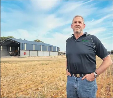  ??  ?? BIG BUILD: The Wheelhouse Group’s Wes Wheelhouse in front of his 3000-tonne fertiliser shed in Bridgewate­r.