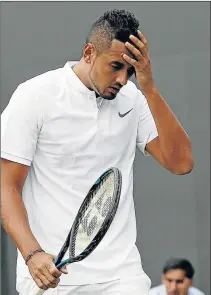  ?? Picture: AFP ?? POOR LUCK BITES: Australia’s Nick Kyrgios reacts against France’s Pierre-Hughes Herbert during their men’s singles first round match on the first day of the Wimbledon Championsh­ips at The All England Lawn Tennis Club in Wimbledon, southwest London...