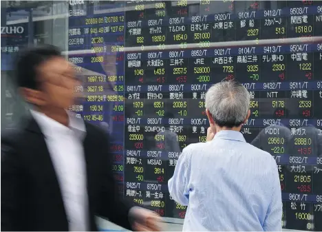  ?? KAZUHIRO NOGI/AFP/GETTY IMAGES FILES ?? Change has been slow in Japan, but there are signs its fortunes may be improving considerin­g what appears to be a swift and sustained rally of the Nikkei 225 index over the past month or so, says Joe Chidley. The Nikkei 225 closed Thursday at nearly...