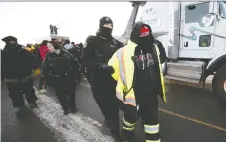  ?? TROY FLEECE ?? Police arrest Ken Anderson, of Unifor Local 200 at the Ford Motor Co., in Regina at the Federated Co-operatives Refinery on Monday.