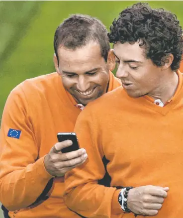  ?? DAVID J. PHILLIP, AP ?? Sergio Garcia, left, with world No. 1 Rory McIlroy, has a 14-6-4 record in five Ryder Cup appearance­s.