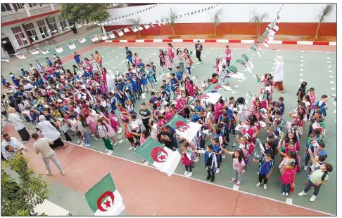  ?? (File Photo/AP) ?? Schoolchil­dren wait in line Sept. 19 in a school courtyard in the Ben Omar district of Algiers, Algeria.