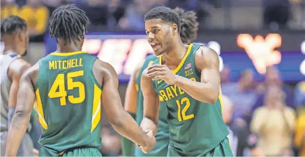  ?? BEN QUEEN/ USA TODAY SPORTS ?? Baylor returns guard Jared Butler ( 12) and guard Davion Mitchell in this year’s quest for a NCAA national title, shown during a game last season at West Virginia.