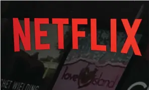  ?? (AP/Richard Drew) ?? The Netflix logo is shown over film and television offerings on the company’s website in February 2023. Netflix reported earnings on Tuesday.