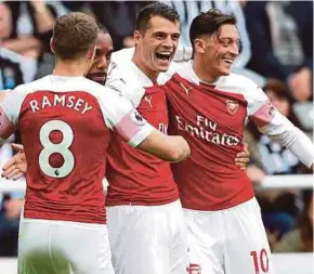  ?? REUTERS PIC ?? Arsenal’s Granit Xhaka (second from right) celebrates scoring with (from left) Aaron Ramsey, Alexandre Lacazette and Mesut Ozil on Saturday.