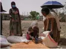  ?? Jemal Countess/Getty ?? An aid worker distribute­s lentils in Mek’ele, the capital of Tigray. Photograph: