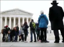  ?? JACQUELYN MARTIN — THE ASSOCIATED PRESS ?? People wait in line to enter the Supreme Court, Wednesday in Washington, where the court is hearing arguments on a gerrymande­ring case.