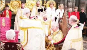  ?? ?? The Archbishop of Canterbury Justin Welby places the St Edward’s Crown onto the head of Britain’s King Charles III during the Coronation Ceremony inside Westminste­r Abbey in central London The set-piece coronation is the first in Britain in 70 years, and only the second in history to be televised