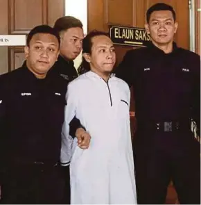  ?? FILE PIC ?? Mohd Al-Arshy Mus Budiono being led to the Sessions Court in Kuala Lumpur in February.