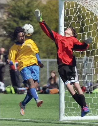  ?? DAVID BEBEE, RECORD STAFF ?? Galt Ghosts forward Robel Wubute heads the ball past Glenview Park Panthers goalie Andrei Ignea for his team’s third goal in the second half Tuesday at RIM Park. Galt won the contest, 6-1.