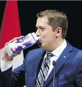  ?? FRED CHARTRAND / THE CANADIAN PRESS ?? Conservati­ve Leader Andrew Scheer takes a swig of milk as he takes the stage at the National Press Gallery Dinner last June, after he was named party leader.