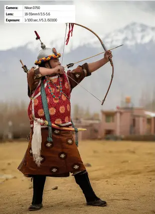  ?? ?? [3] The mountains provide a stunning backdrop to this photograph of a Ladakh man drawing his bow and arrow while performing the
spao dance. Camera: Nikon D750 Lens: 18-55mm f/3.5-5.6 Exposure: 1/100 sec, f/5.3, ISO100