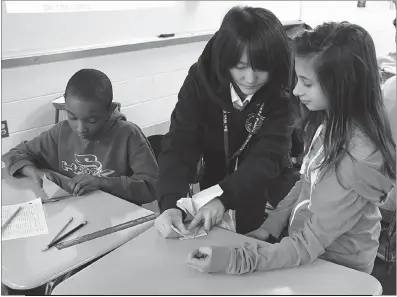  ?? SUBMITTED PHOTOS ?? Bunkyo University student teacher Rito Ikeda, center, helps Milton M. Somers Middle School sixth graders Terrell Pullen, left, and Kristin Tojek make paper cranes during their social studies class.