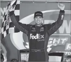  ?? Mark Humphrey / The Associated Press ?? Denny Hamlin celebrates in Victory Lane after winning Saturday’s Sprint Cup Series race at Bristol Motor Speedway.