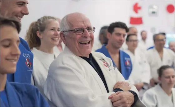  ?? PETER LEE WATERLOO REGION RECORD ?? Bob Zettl, centre, laughs at a humorous anecdote during words of tribute at his ceremonial bowout at Kaizen Judo Club on Lancaster Street in Kitchener on Friday.