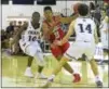  ?? PETE BANNAN — DIGITAL FIRST MEDIA ?? Carroll’s AJ Hoggard splits Malvern Prep defenders Tygee Leach (10) and Connor Leyden (14) in the second quarter Friday evening.