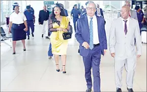 ?? (Pics: Sibusiso Zwane) ?? PM Cleopas Sipho Dlamini and Minister of Tourism and Environmen­tal Affairs, Moses Vilakati sharing a light moment at KM III Internatio­nal Airport yesterday afternoon. Behind them is the PM’s wife, Nomfundo.