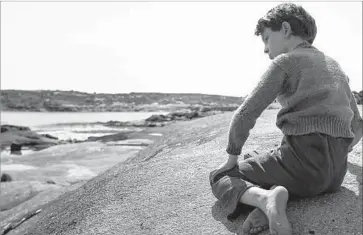  ?? Photograph­s by Laurent Guerin ?? PORTRAYING folk singer Joe Heaney as a youngster, Colm Seoighe absorbs the sights and sounds of Ireland.