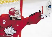  ??  ?? Goalie Kevin Poulin, of Canada, grabs the puck during a game against South Korea at the 2018 Winter Olympics on Sunday.