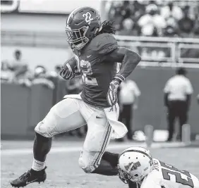  ?? AP PHOTO/BUTCH DILL ?? Alabama running back Najee Harris, left, tries to escape the tackle of Arkansas State defensive back Brandon Byner on Saturday in Tuscaloosa, Ala. Alabama won 57-7.