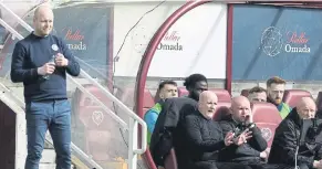  ?? ?? Steven Naismith, left, and David Martindale occupy the benches in the local derby at Tynecastle