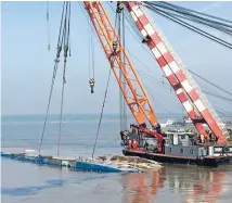  ?? Photo: REUTERS ?? Cranes work on righting the capsized Eastern Star cruise ship at the Jianli section of the Yangtze River. The battered ship was later righted and authoritie­s said there was no chance of finding anyone else alive.