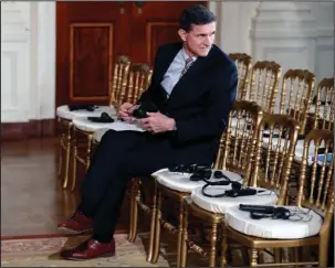  ?? The Associated Press ?? FIFTH AMENDMENT: In this photo taken Feb. 10, then-National Security Adviser Michael Flynn sits in the front row in the East Room of the White House in Washington. Attorneys for Flynn say that a daily “escalating public frenzy against him” and the...