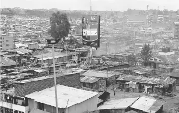  ??  ?? A billboard displaying photos of Kenyatta and deputy president William Ruto from the Jubilee party in Mathare slum, in Nairobi, Kenya. — Reuters photo Uhuru Kenyatta, Kenya President