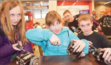  ?? STEVE MacNAULL/The Okanagan Saturday ?? Grade 6 Rutland Middle School students Katie Galigan, left, Tammalee Hicks and Jacob Kochylema toyed with magneto motors used in aircraft engines at Friday’s Skills Canada B.C. 20th anniversar­y celebratio­n at Okanagan College Trades Complex at the...